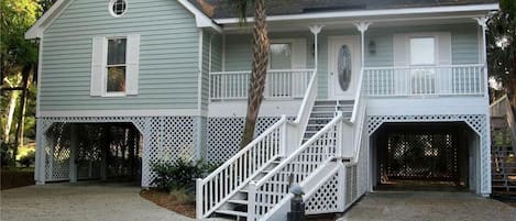A two-story house with a porch, a staircase, and a garage.