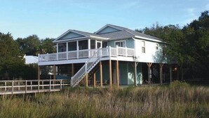 A two-story house with a balcony and a covered deck area.