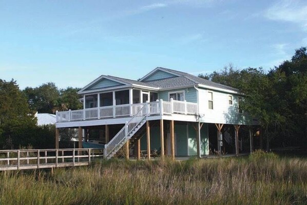 A two-story house with a balcony and a covered deck area. - Watercolors (Edisto Island)