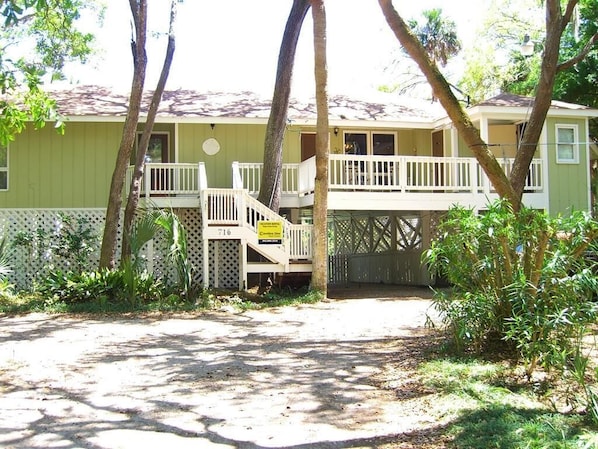 A two-story house with a balcony and a porch.