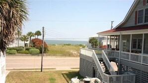 A beachfront property with a covered porch, a boat dock, and a view of the ocean. - Green Parrot (Edisto Island)