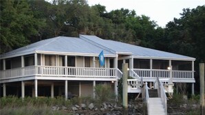 A waterfront house with a covered porch and a dock. - Shrimpers Cove (Edisto Island)