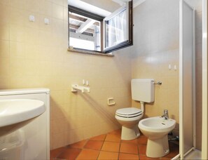 A bathroom with a toilet, bidet, and sink. - Casa Marmolada by Interhome (Canazei)