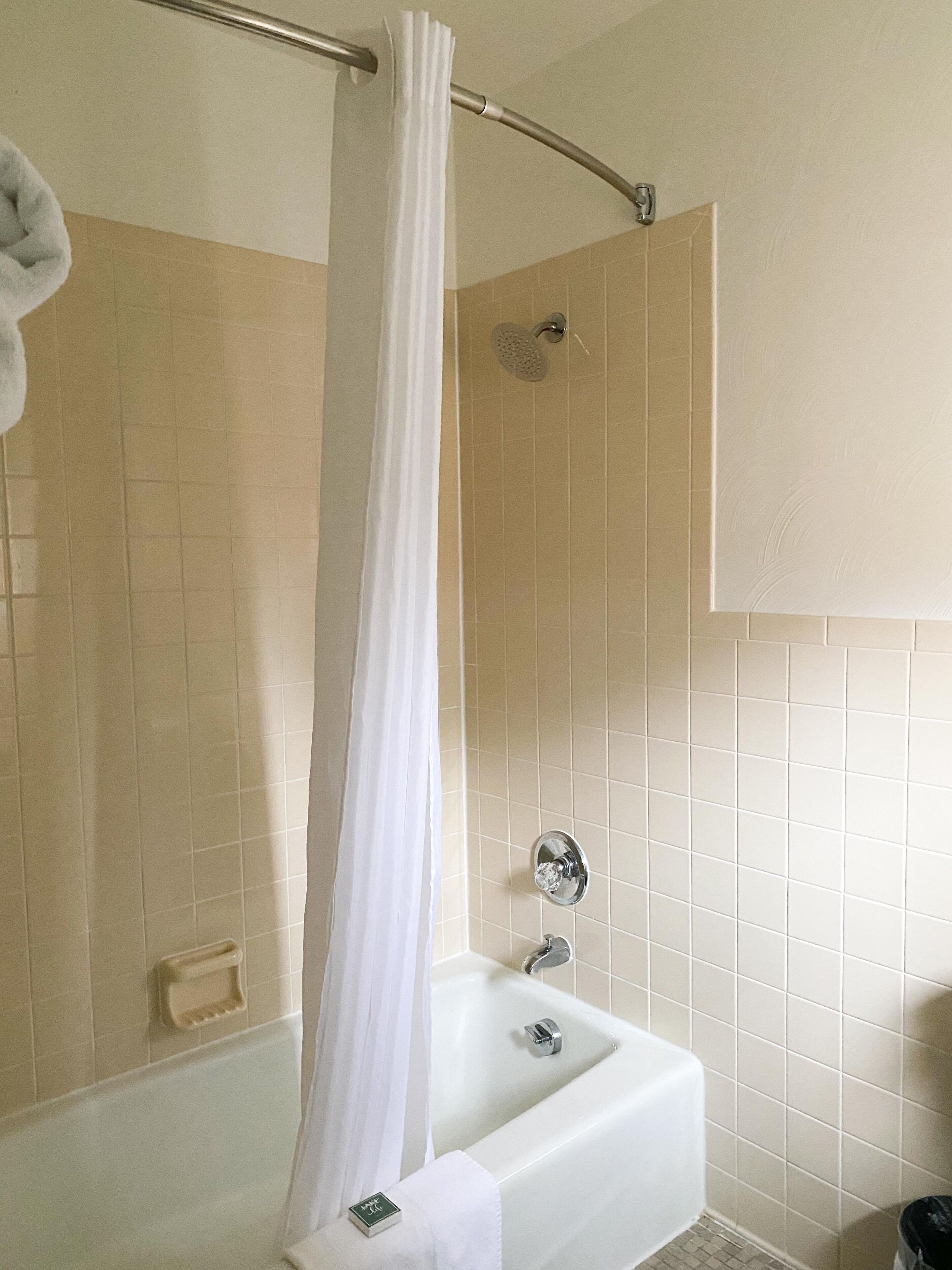 Combined shower/bathtub, designer toiletries, hair dryer, towels
