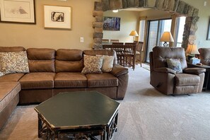 A living room with a sectional sofa, a recliner, and a coffee table.