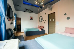 A modern hotel room with a sofa, two beds, a desk, and a bathroom visible through an open door. - Gia Han Hotel (Xuan Huong - Da Lat)