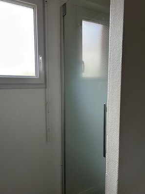 Shower, hair dryer, towels, toilet paper
