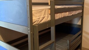 A bunk bed room with a wooden frame and a mattress on the top bunk. - Cozy Studio for 4 with South-Facing Balcony, Near Slopes and Shops - Pet Friendly (Huez)