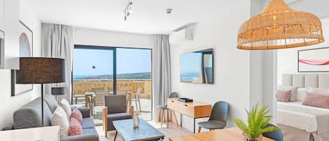 A modern hotel room with a balcony, a dining area, and a living space.