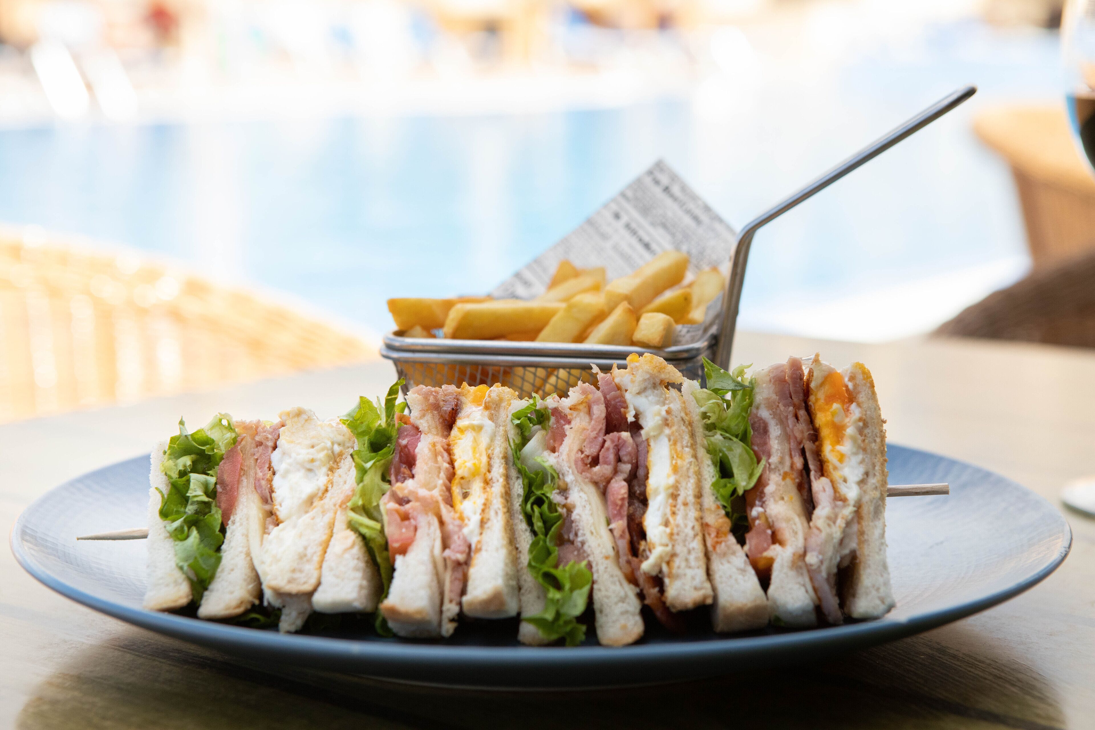 A plate of sandwiches with a side of fries.
