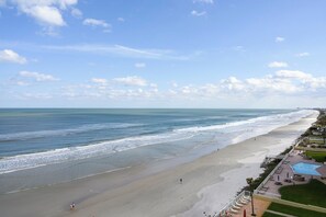 A beach with a swimming pool and a view of the ocean. - #803 Shores Club Oceanfront Traffic Free Beach 2/2 (Daytona Beach Shores)