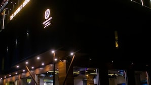 A building with illuminated signage reading "The Infinity Resort."