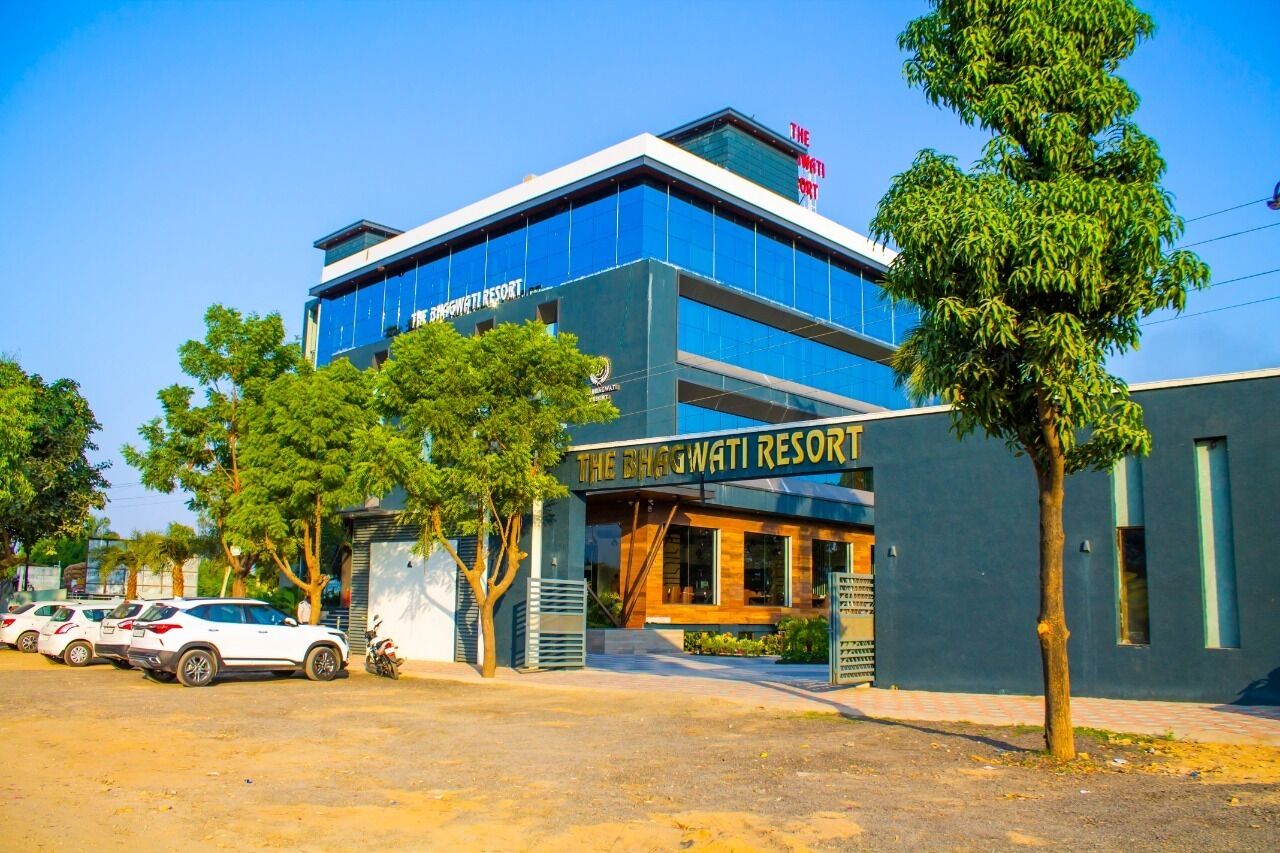 A modern building with a sign reading "The Bhagwati Resort".