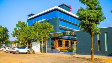 A modern building with a sign reading "The Bhagwati Resort".