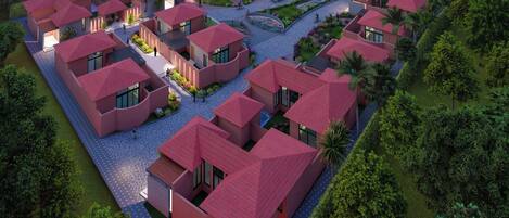 Un ensemble résidentiel composé de plusieurs maisons aux toits rouges, disposées selon un plan en forme de grille, et entouré de verdure.