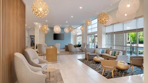 A spacious living area with modern furniture, large windows, and decorative lighting. - Element by Marriott Atlanta Buckhead (Atlanta)