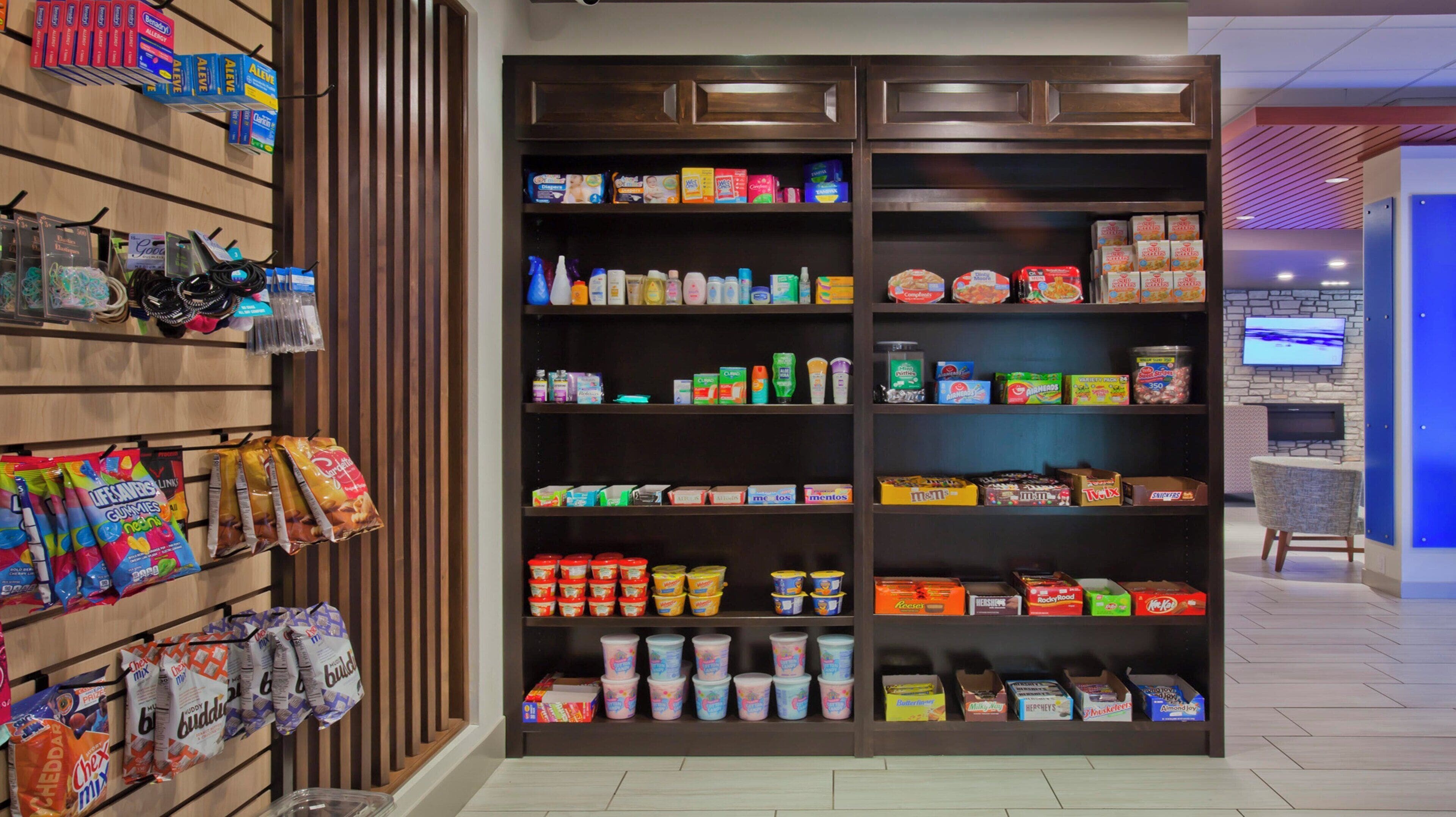 A candy and snack display in a store with various brands and types of products.