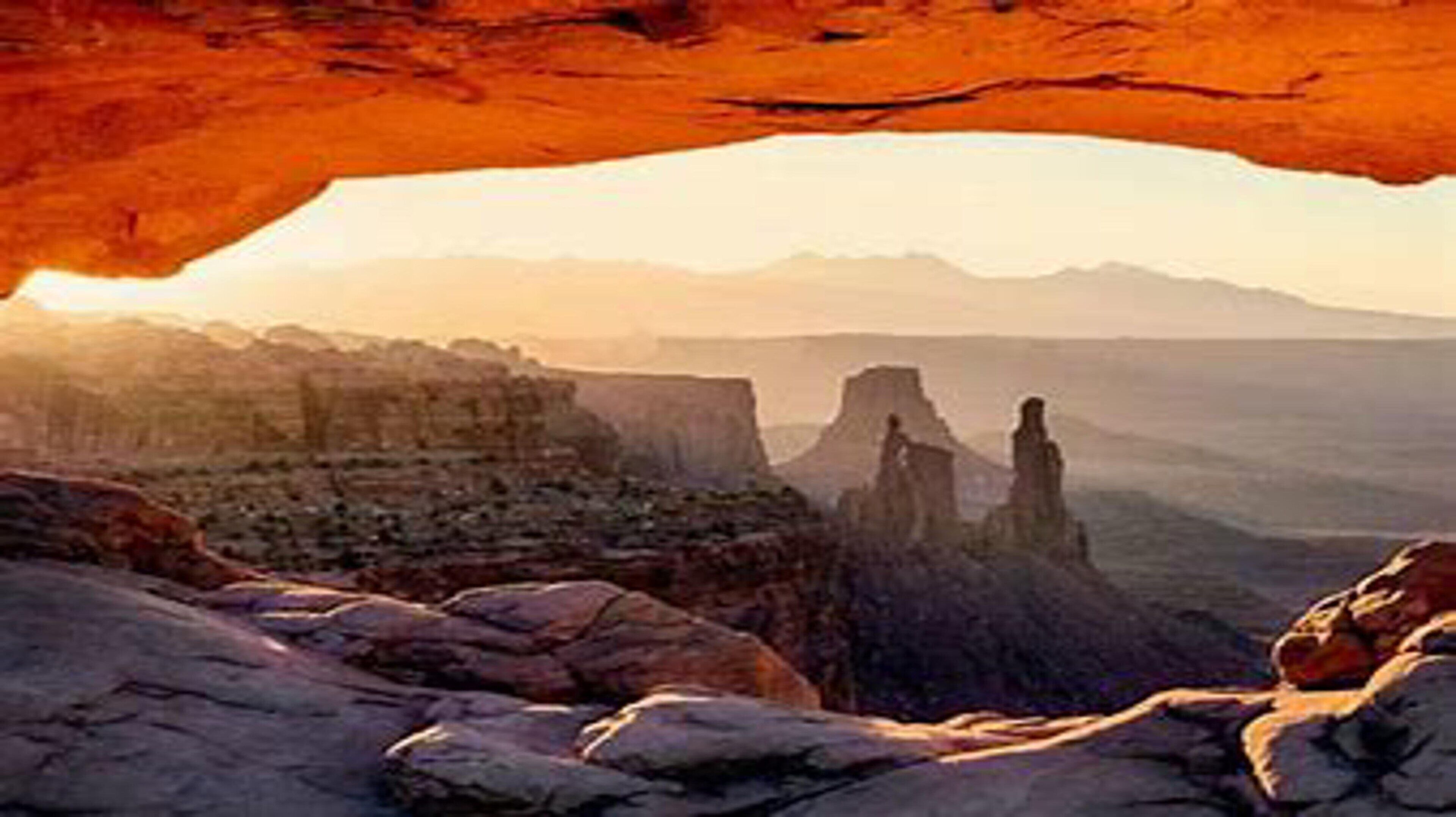 A rugged landscape with prominent rock formations and a clear sky.