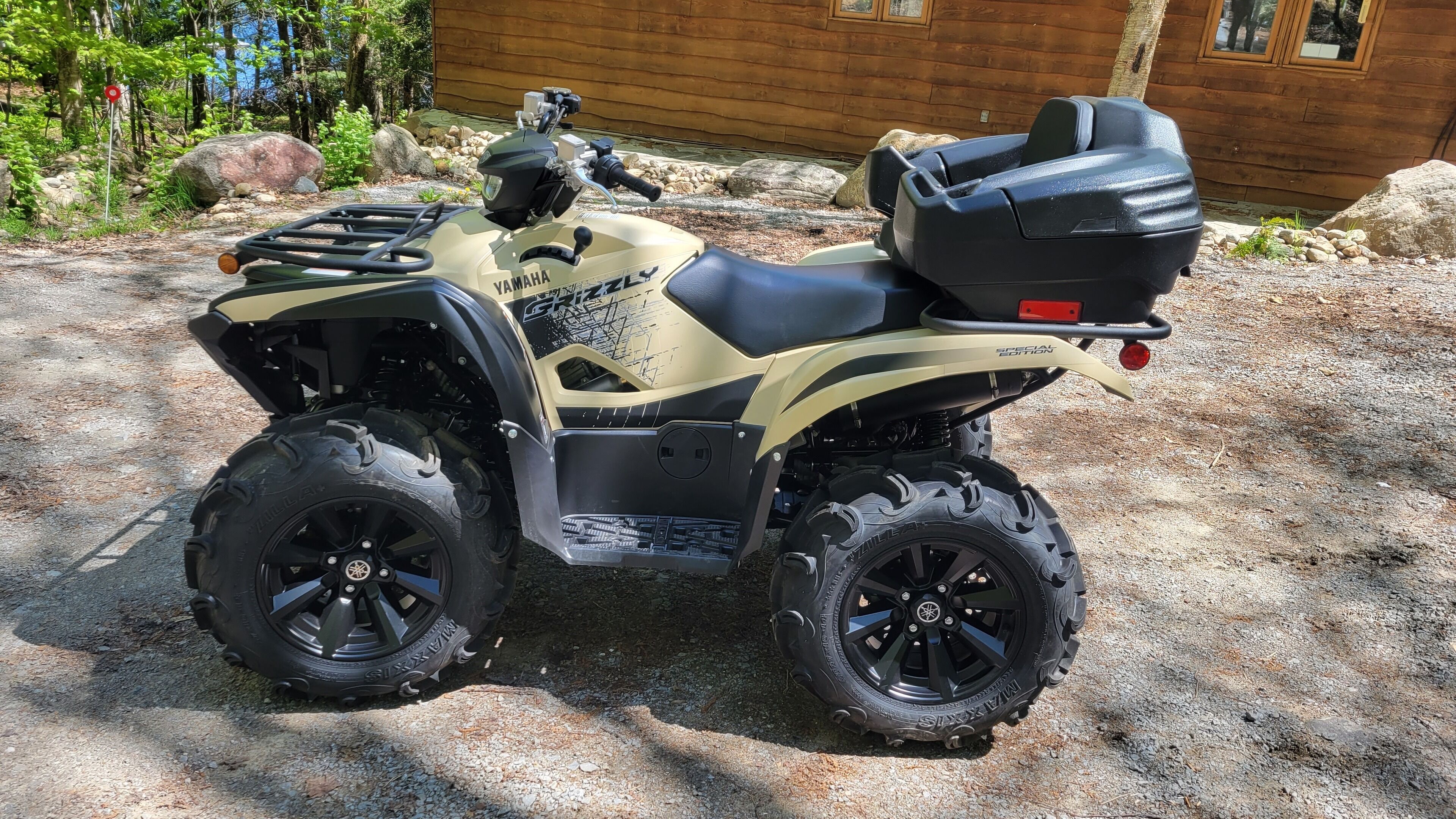 A Yamaha GX 125 ATV parked on gravel.