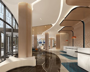 A modern hotel lobby with high ceilings, large windows, and a central seating area.
