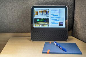 A tablet displaying a hotel booking interface with a room layout and amenities. - Holiday Inn Express Shanghai Zhangjiang by IHG (Shanghai)