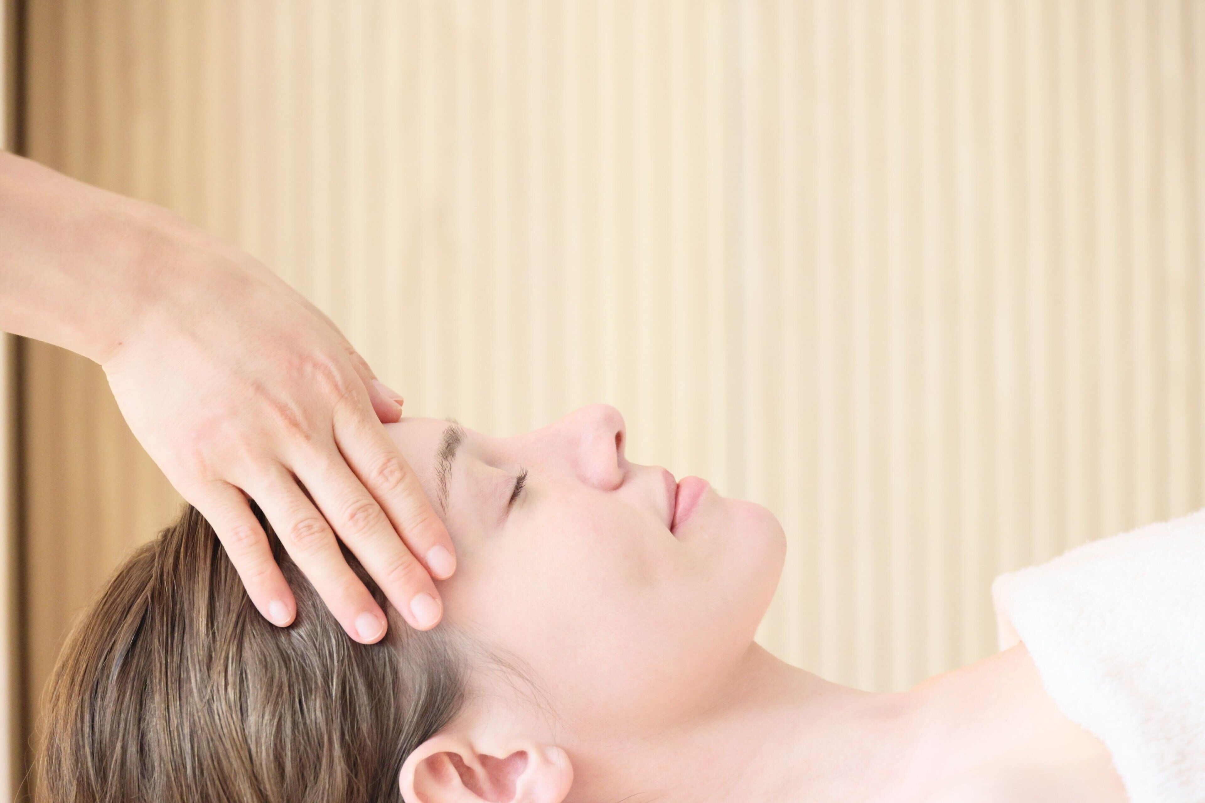 A person receiving a head massage.