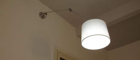 A ceiling-mounted lamp fixture with a cylindrical shade.