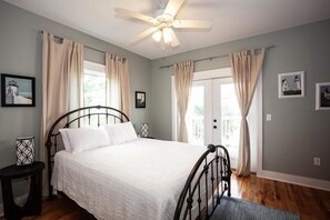 A bedroom with a bed, a ceiling fan, and curtains. - Gulf views, steps to pool, fire pit, pet friendly, beach gear included! (Port St Joe)