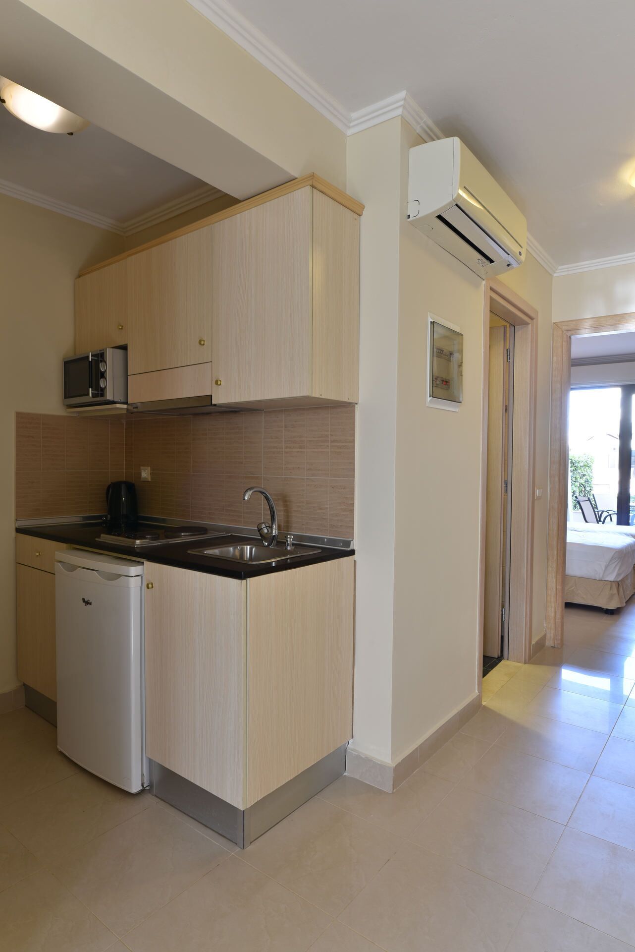 mini-fridge, microwave, stovetop, electric kettle