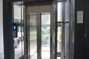 Elevators offer a sleek, modern ride with a clear view of the interior.
