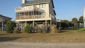 A two-story house with a balcony and a covered porch area.