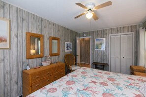 A bedroom with a bed, dresser, chair, wardrobe, and ceiling fan. - Pet Friendly w/ Fenced Yard; Screened Porch & Sun Deck; Easy Beach Access; Cable TV/WiFi (Edisto Beach)