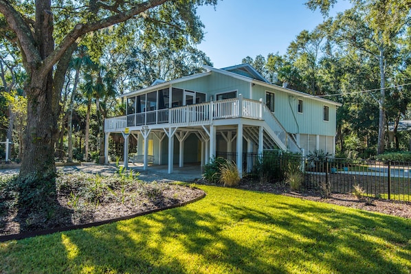 A two-story house with a balcony and a covered porch.