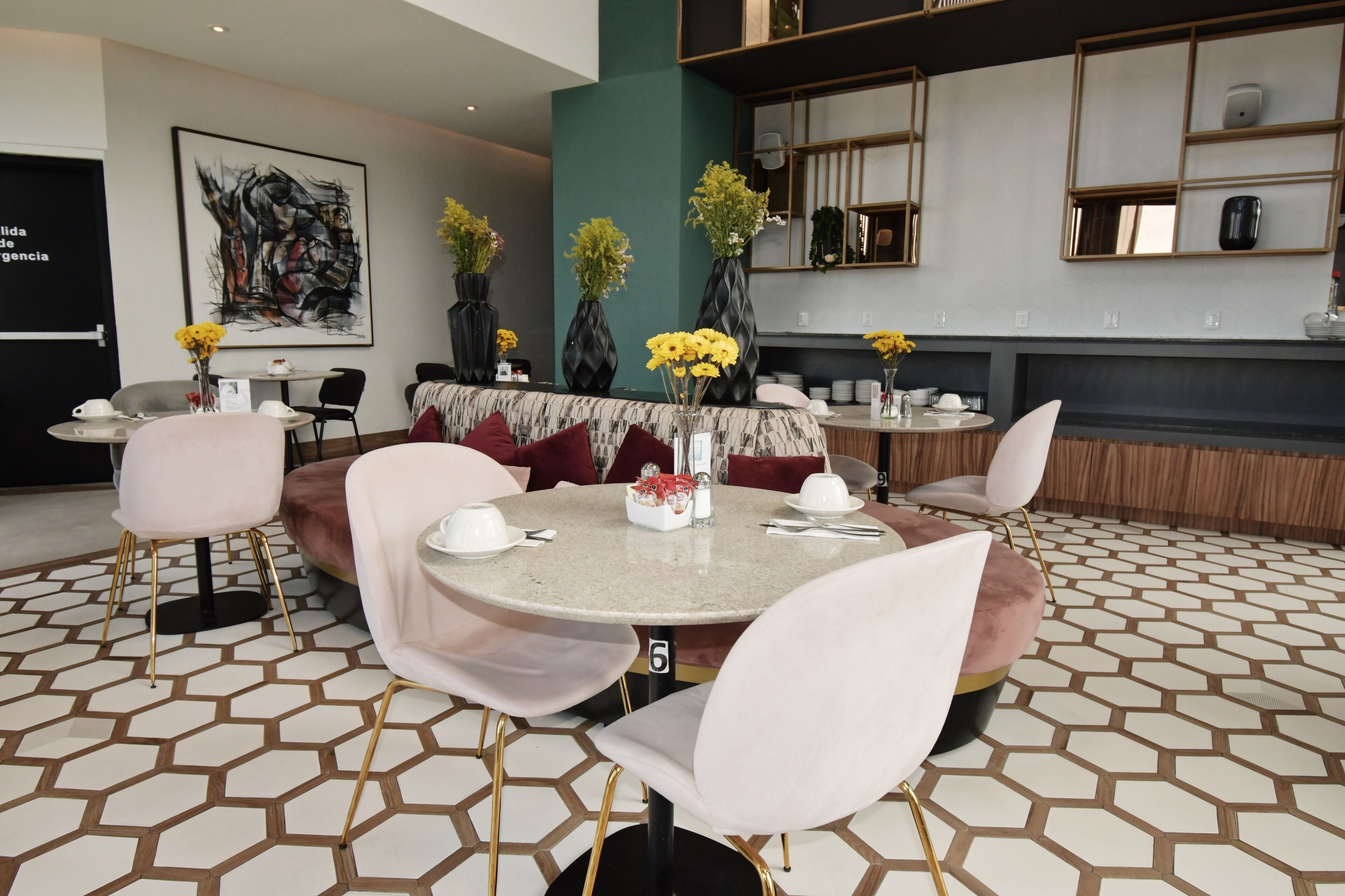 A modern dining area with round tables, white chairs, and decorative vases.