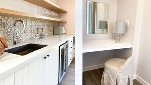 A modern kitchen with a built-in sink, a backsplash with a geometric pattern, and a wooden shelf above the counter.