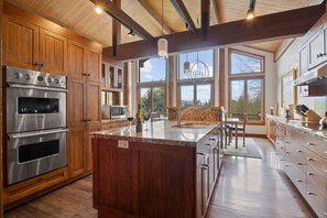 Enjoy cooking in this well-lit kitchen with a large island and double oven.
