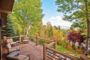 Relax on the deck with a view of lush green surroundings.