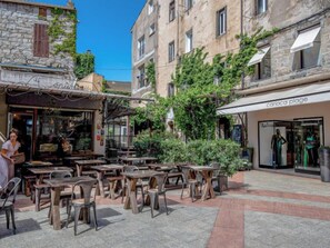 Relax in a charming outdoor café amidst historic stone buildings and boutique shops.