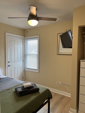 2 habitaciones, escritorio y tabla de planchar con plancha