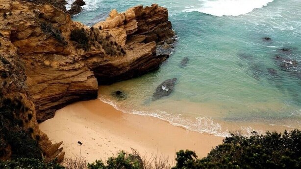 A coastal landscape with a sandy beach, rocky cliffs, and clear turquoise water. - The Outlook - Quiet and Tranquil with Lovely Views (Bermagui)