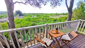 A wooden deck with a table and two chairs, a bottle of champagne, and two glasses on a tray. - The Outlook - Quiet and Tranquil with Lovely Views (Bermagui)