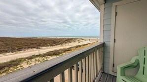 A balcony with a view of a beach and ocean. - Beachside Escape | Heated Pool, Hot Tub & Ocean Views (Corpus Christi)