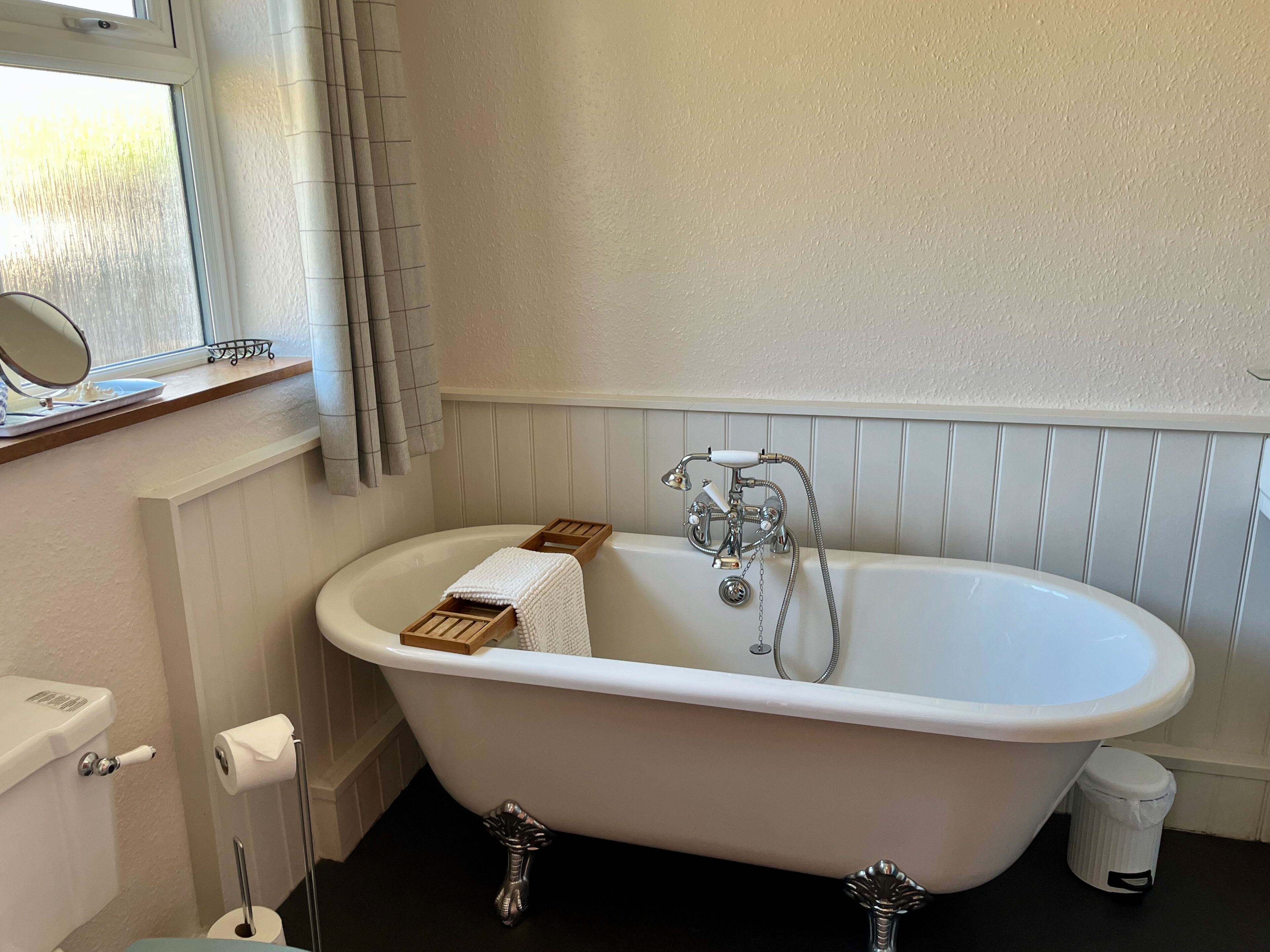 Spacious & welcoming bathroom with roll top bath and separate shower.