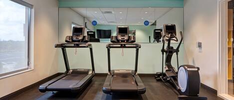 A fitness center with treadmills, an elliptical, and a stationary bike.