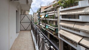 A multi-story residential building with balconies, railings, and visible windows. - Stunning Apt near Acropolis Museum by GHH (Athens)