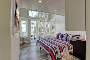 A bedroom with a bed, a TV, and a window. - 28 Carters Manor- Oceanfront Compound, Two Private Pools (Hilton Head Island)