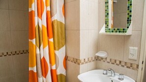 A bathroom with a shower curtain, a sink, and a mirror. - DEPARTMENT WITH EXCELLENT LOCATION (San Carlos de Bariloche)