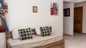 A cozy room with a wooden bench bed, two pillows with a polka dot pattern, and two framed artworks on the wall. - DEPARTMENT WITH EXCELLENT LOCATION (San Carlos de Bariloche)