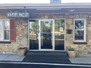 A stone building with a sign reading "OFFICE" above the entrance. - Gateway Inn (Front Royal)