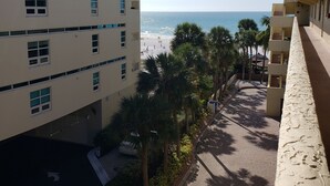 A multi-story building with a view of the beach and palm trees. - On Siesta Key beach  , condo w/ heated pool, w/ beautiful 4th floor view (Sarasota)